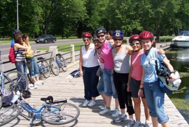 group of people standing beside a bike